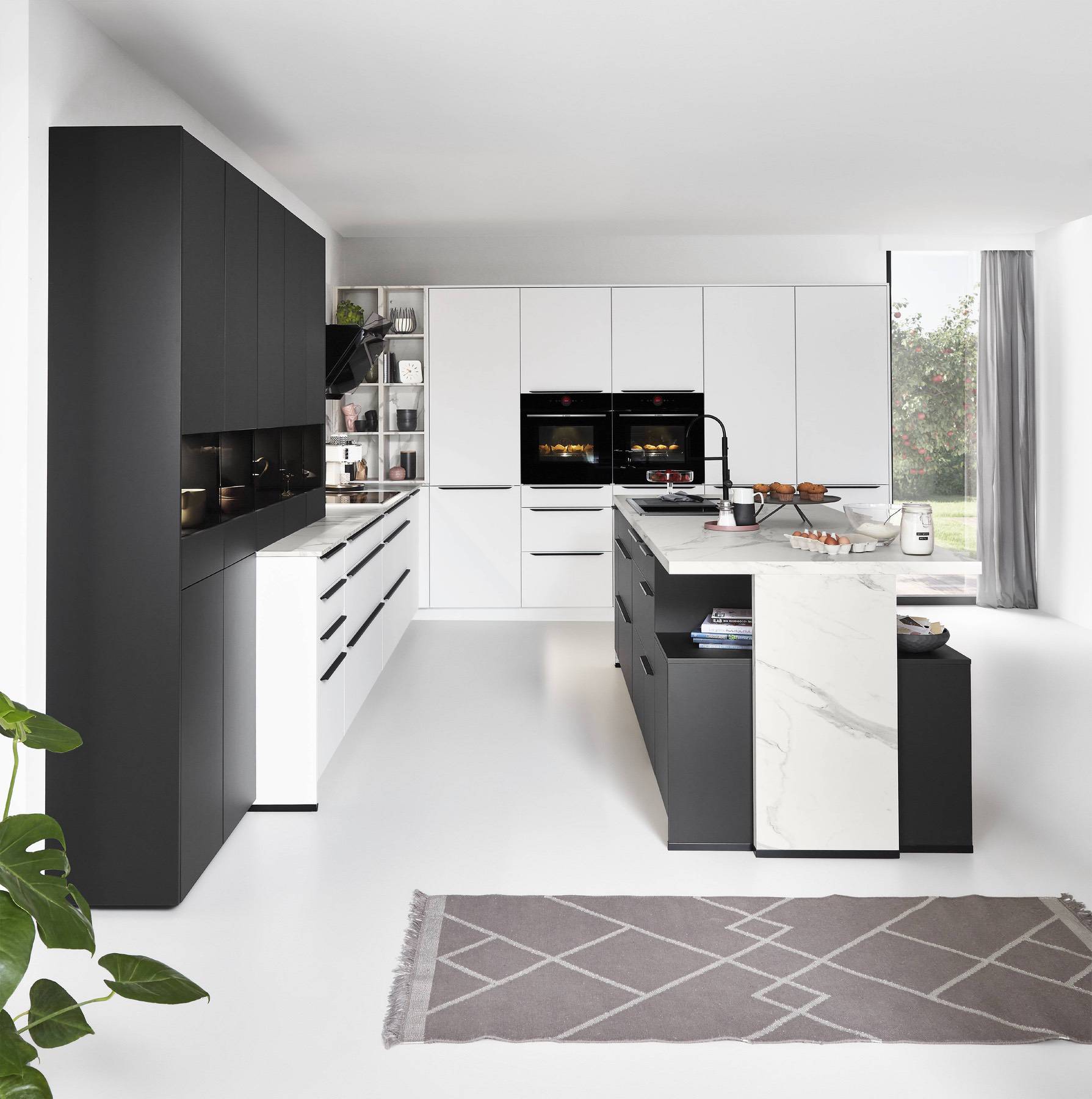 A monochrome kitchen colour scheme using layered shades of grey and black for a sleek, modern finish. | My Kitchen Specialist